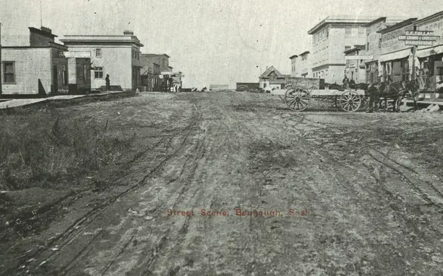 Street Scene, unpaved main street with horse-drawn wagon
